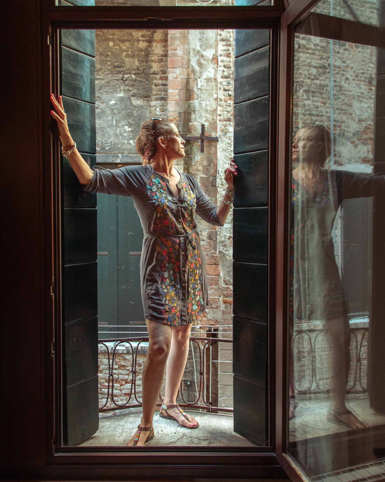 woman standing in window in Venice Italy