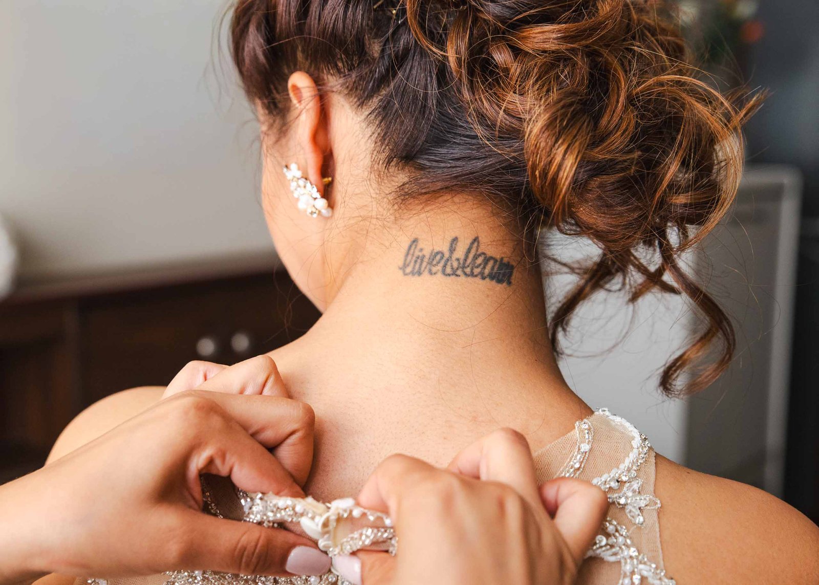 bride putting on wedding dress