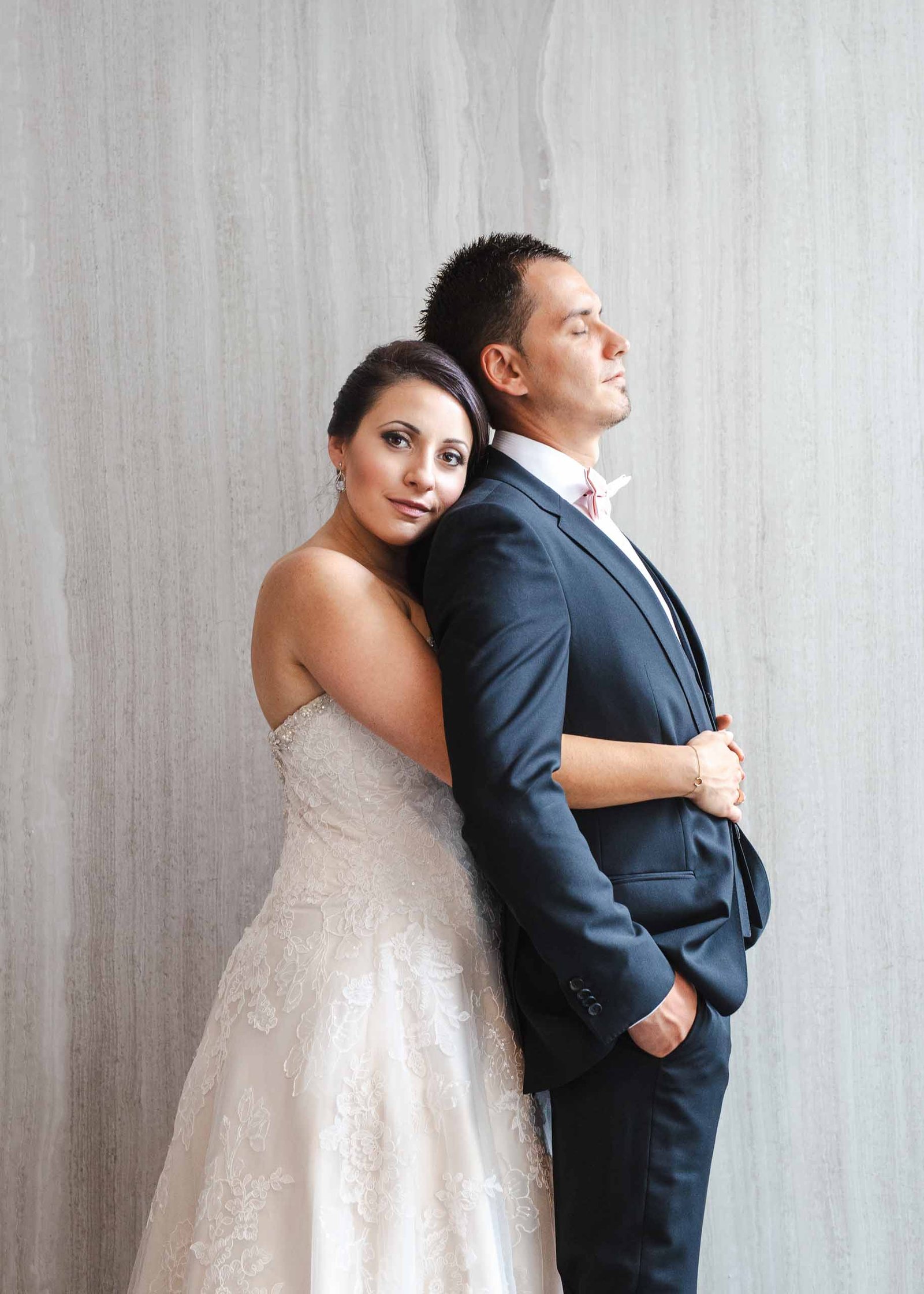 bride standing behind groom
