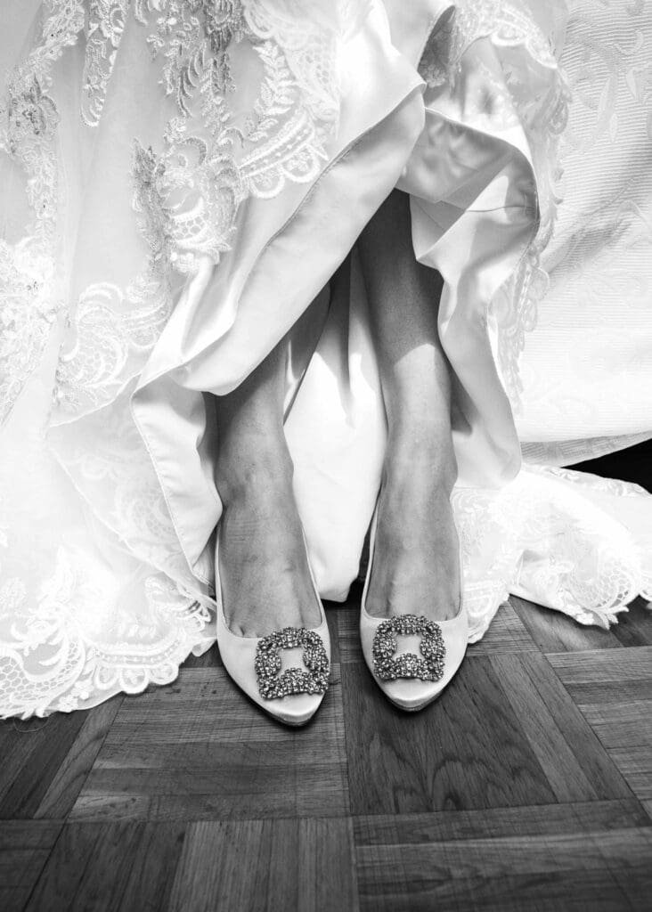 brides shoes beneath wedding dress